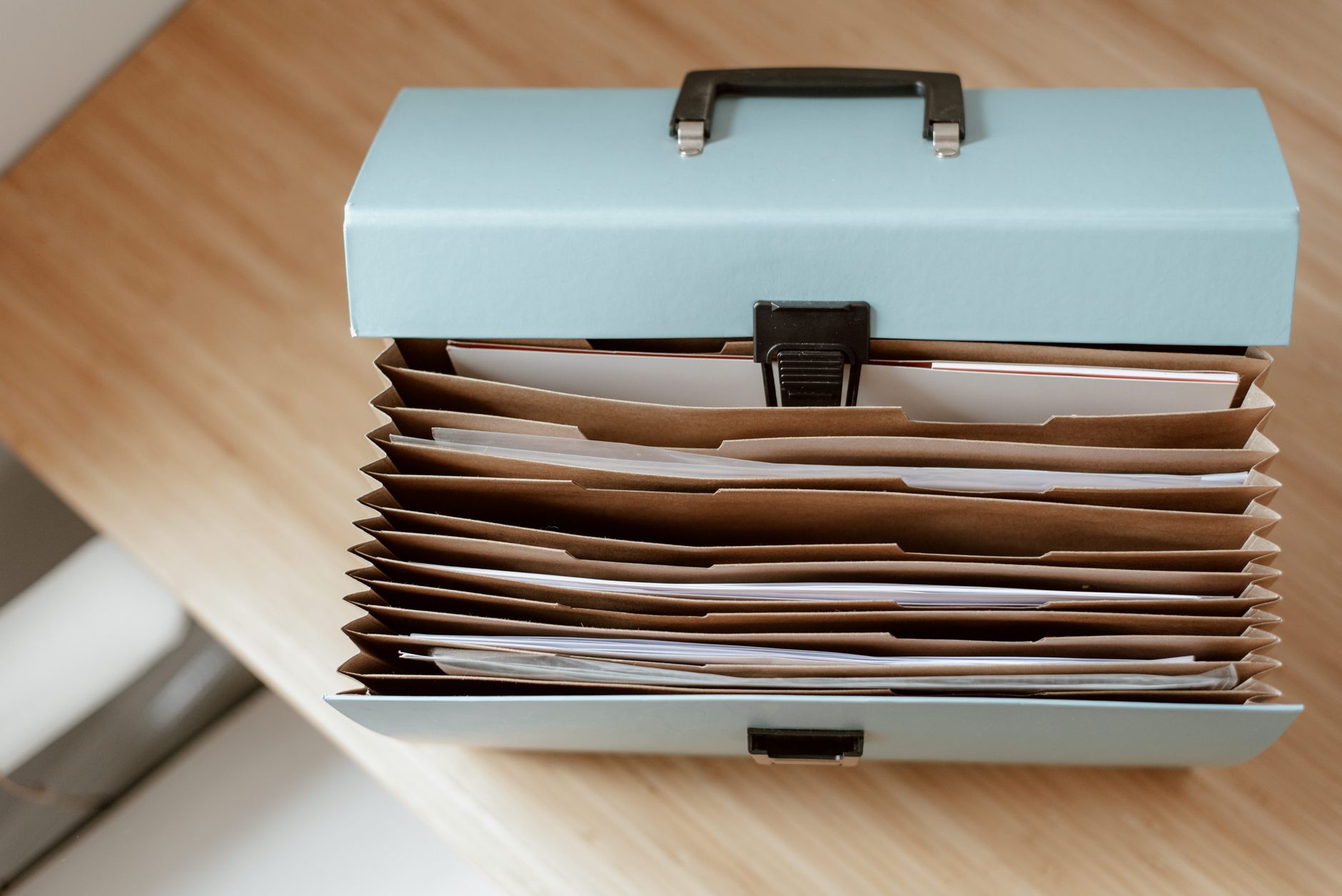 Legal administrative professional organizing case files at a desk